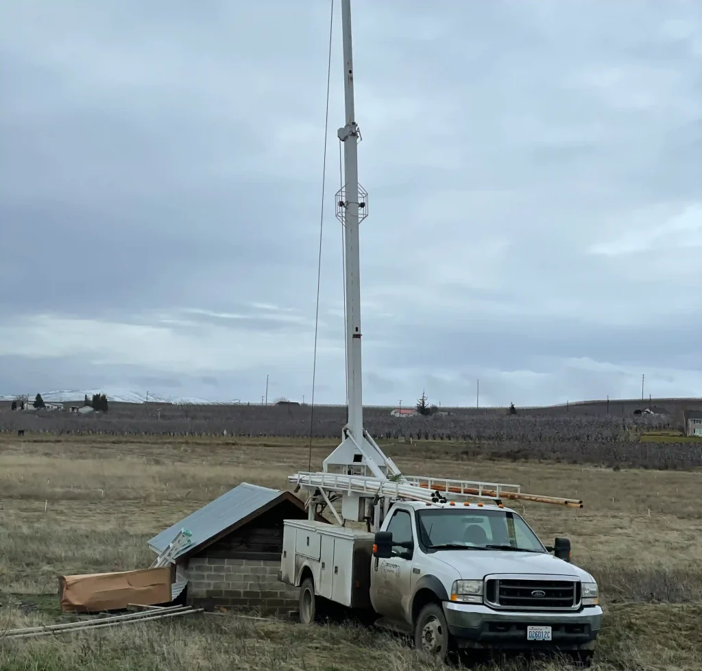 Castle Pump and Electric crane truck at a job site.