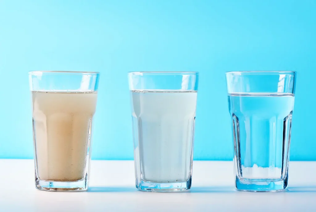 Three cups demonstrate differences in water quality
