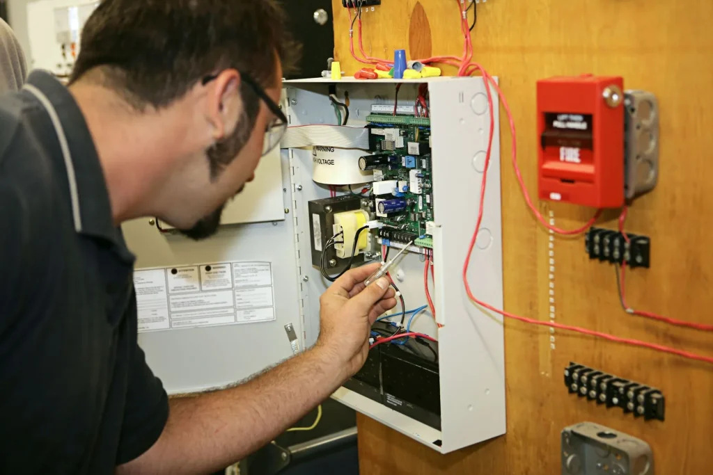 Yakima electrician working on a low-voltage fire system