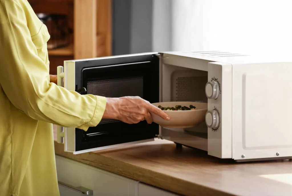 A homeowner using a microwave oven.