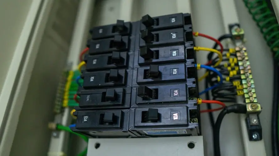 A series of electrical breakers during a panel installation.