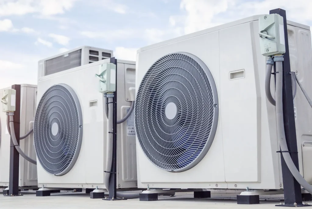 A series of HVAC condensers on a rooftop.