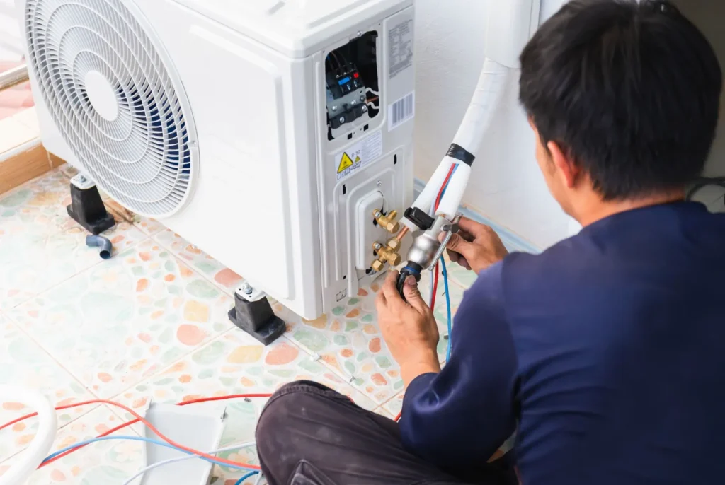 A technician works on an indoor HVAC install.