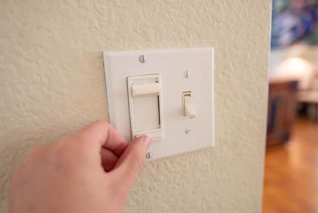 A light switch with a dimmer slider.
