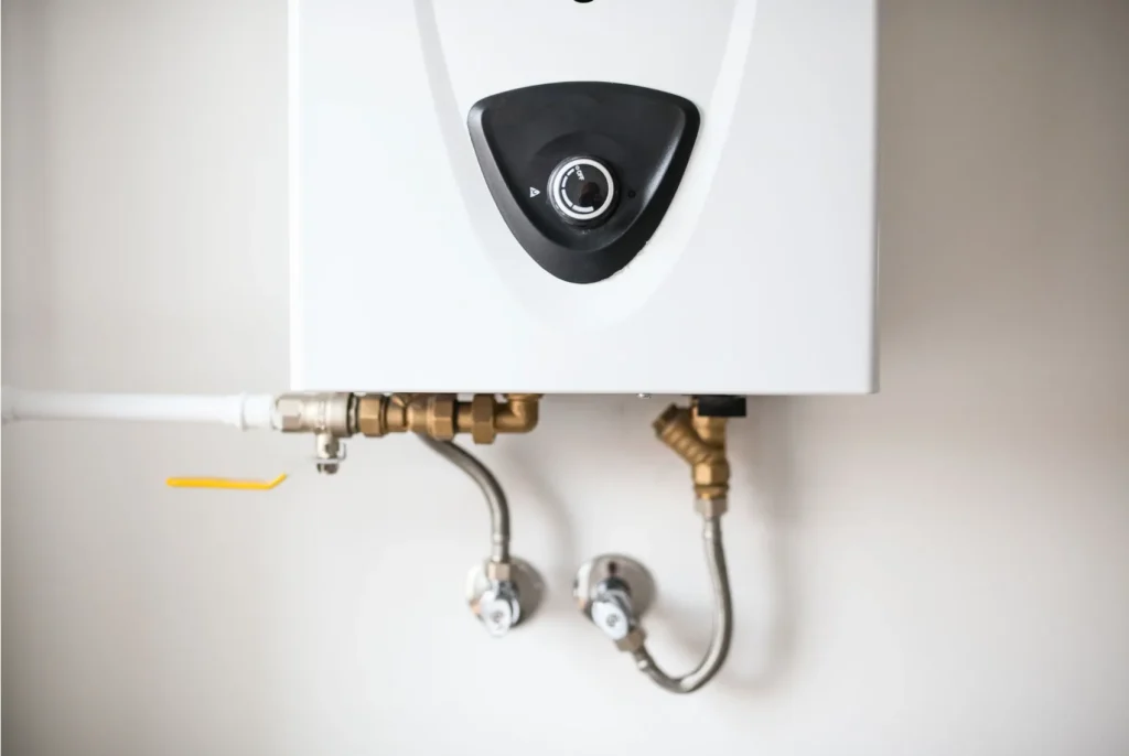 A tankless hot water heater on a wall.