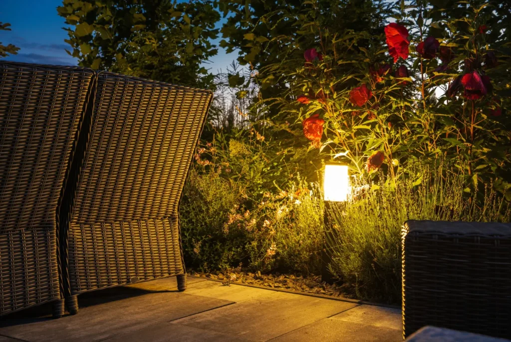 An outdoor lamp by a wicker garden chair.